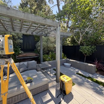 Total station set up in a landscaped residential yard